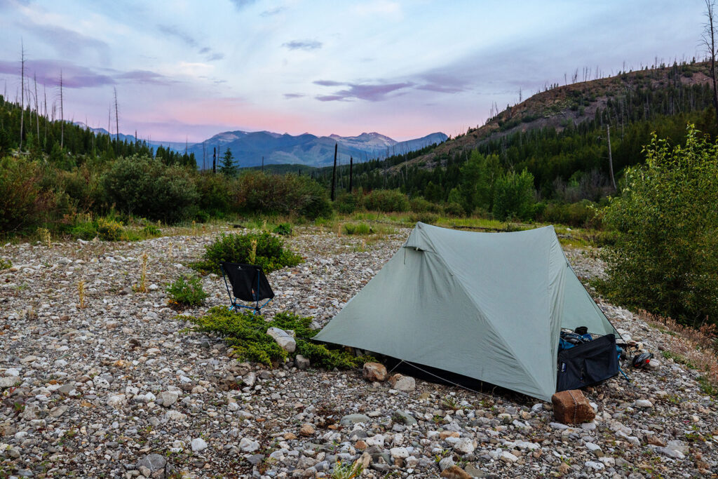 Backpacking tent pitched beside a rocky riverbed at the final campsite in Montana's Bob Marshall Wilderness.