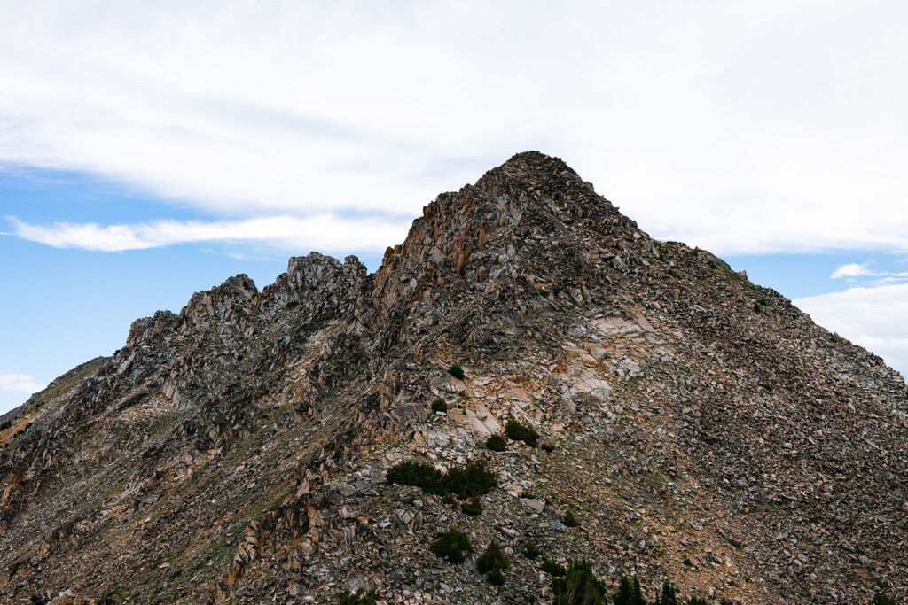 Rocky mountain peak viewed from a ridgeline during a backpacking trip in Montana.
